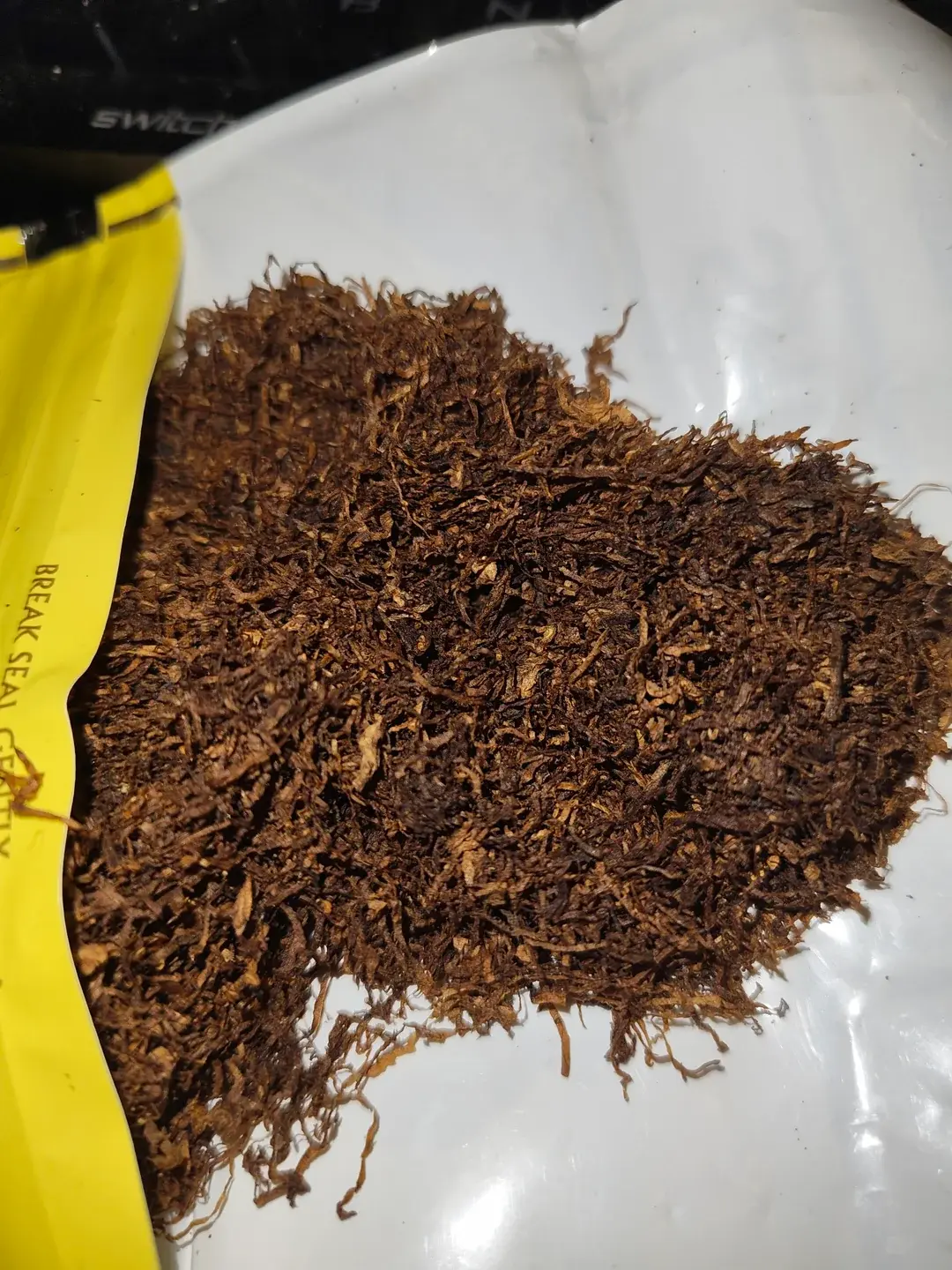 Opened pouch with fresh tobacco close-up